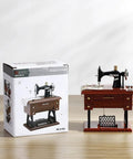 Handcrafted Vintage Sewing Machine Music Box With Wind Up Mechanism beside its packaging on a wooden surface.