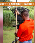 Person using Vertical Hand Tool Rack For Open Trailers Holds Up To Six Straight Handle Tools Like Shovels Rakes And Hoes With Secure Upright Storage
