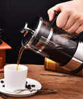 French Press Coffee Maker With Ergonomic Handle, Food Grade Stainless Steel Turkish Coffee Pot And Espresso Brewer pouring coffee