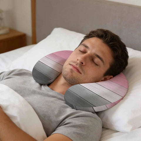 U Shaped Memory Foam Travel Neck Pillow With Pink Wood Grain Finish used by man resting in bed for head support and comfort
