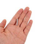 Hand holding a small screw from 80 Piece Aluminum Dent Puller Kit For Auto Body Repair 4mm Rivet Nuts Precision Dent Removal Tool Pro Grade Heavy Duty