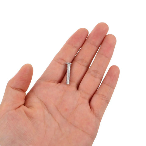 Hand holding a small screw from 80 Piece Aluminum Dent Puller Kit For Auto Body Repair 4mm Rivet Nuts Precision Dent Removal Tool Pro Grade Heavy Duty