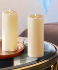 Flameless Pillar Candles Set Of 3 With Remote Real Ivory Wax 3D Flickering LED Flame 3 Inch Diameter Batteries Included For Christmas Party Decor And Cozy Home Vibe, two candles on a table.