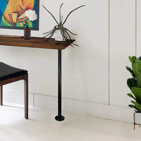 Elegant table with black metal steel pipe leg, showcasing DIY home decor using 6 Pack Half Inch Steel Pipes Four Inch Long for shelving.