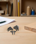 Old School Box Corner Protectors Set for Wood Furniture, metal edge guards, 50Pcs on wooden tabletop with pencil