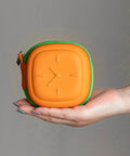 Heavy Duty Eva Travel Case For 140W Fast Charger And Usb C Cable Organizer in orange and green held in hand.