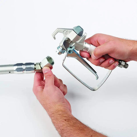 Hands connecting components of Pressure Roller Kit For Airless Spray Guns No Tool Attachment With EvenFlow Drip Free Paint Delivery