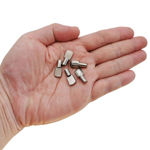 Nickel Plated Shelf Pins Set Of 50 5mm Diameter Fits 1/5 Inch Holes shown in hand for scale, ideal for cabinets and shelves