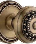 Vintage Brass Soleil Rosette Passage Door Hardware With Parthenon Knob shown close-up with decorative detailing.