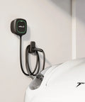 Level 2 Ev Charger 48 Amp Yields A Beefy 11.5 Kilowatts Of Crisp Home Charging Voltage, installed on wall beside a white car.