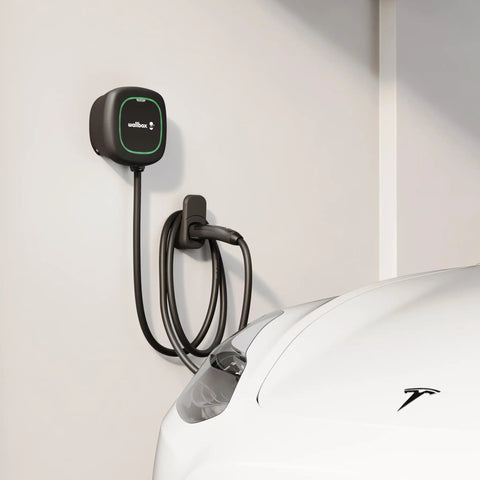 Level 2 Ev Charger 48 Amp Yields A Beefy 11.5 Kilowatts Of Crisp Home Charging Voltage, installed on wall beside a white car.