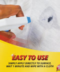 Close-up of Household Spot And Stain Remover being sprayed on a stained white fabric surface.