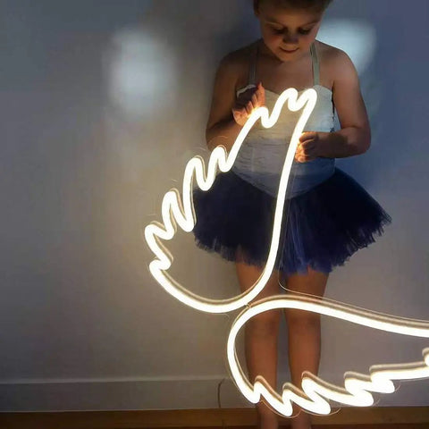 Child interacting with Cloud Neon LED Wall Light Sign USB Powered Night Lamp, cloud-shaped, lit and bright, durable plastic housing.