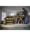 20V Max Bluetooth Jobsite Speaker with 100 ft range on a workbench, visible rugged build and controls
