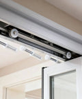 Bi-Fold Door Top Roller Guide Wheel Set installed on folding doors, showing spring-loaded nylon wheel with metal shaft, 7/8 inch diameter