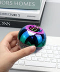 Hand holding Colorful Paper Clips Holder and Dispenser Set with holographic rainbow clips, 28mm paperclips, on keyboard