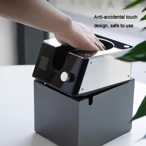 Slick Automatic Coffee Portafilter Cleaner And Espresso Grounds Knock Box Station Featuring Smart Optical Guard in use on countertop.