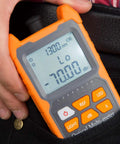 Front view of orange handheld optical fiber power meter with LCD display and orange keypad