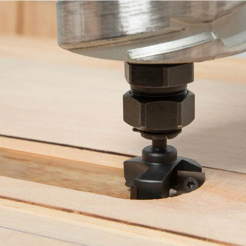 Close-up of Rock Solid One Quarter Inch Shank Slab Flattening Router Bit With Hardened Steel Body cutting wood surface.