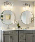 Sleek Two Light Brushed Nickel Vanity Light Fixture Over Mirror With Clear Glass Shades Modern Wall Sconce in bathroom