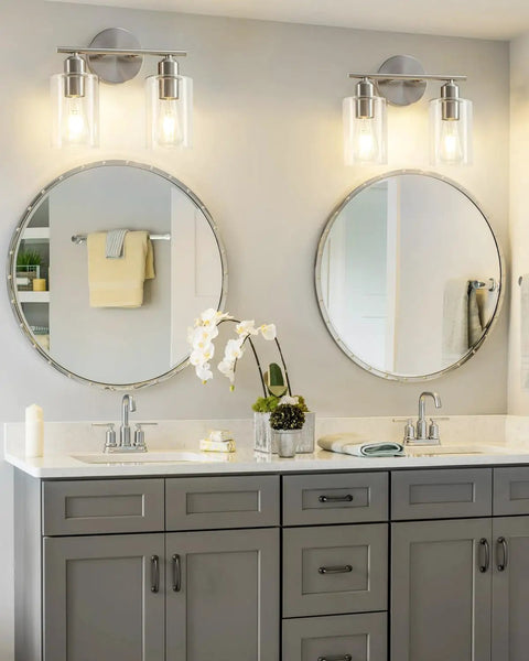 Sleek Two Light Brushed Nickel Vanity Light Fixture Over Mirror With Clear Glass Shades Modern Wall Sconce in bathroom