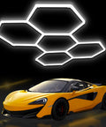 Hexagon Garage Lights LED 25 Pack 220W 26400LM 6500K Daylight White Ceiling Lighting over a sports car