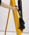 User operating the hydraulic mechanism of the 4000 LB Folding Engine Crane Beefy Steel Hoist Cherry Picker for auto repairs.