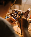 Person using 2 In 1 Hot Air Rework Station Kit With 760W Soldering Iron And Soldering Mat for PCB repair, dual LED display visible