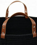Close-up of XXXLarge Cotton Rope Storage Basket With Leather Handles For Living Room Go To Organizer For Blankets Towels And Pillows Black 20x20x13 Inches Durable Cotton Rope Craft With Leather Accents For Laundry Or Decorative Storage, featuring brown leather handles on black woven material.