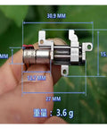 Close-up of 5mm Gearbox Stepper Motor, 8mm Stroke Linear Actuator, held by a hand with dimensions highlighted