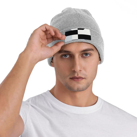 Man wearing Dope Black And White Grid Pattern Knit Beanie Hat For Winter Super Cozy Acrylic Skully Cap.