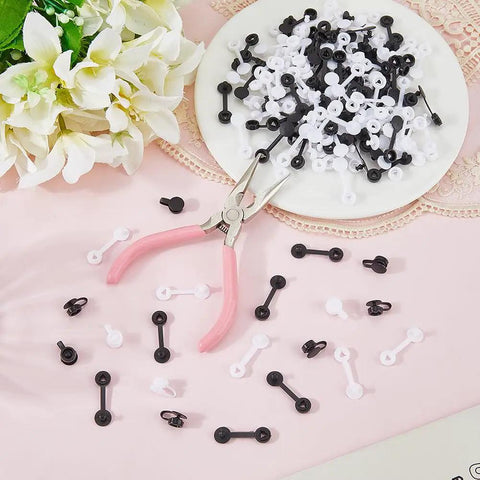 Secure Your Gear Hella Smooth With 300 Black White Tag Fasteners Plastic Flat Round Security Ties on a pink surface with flowers.