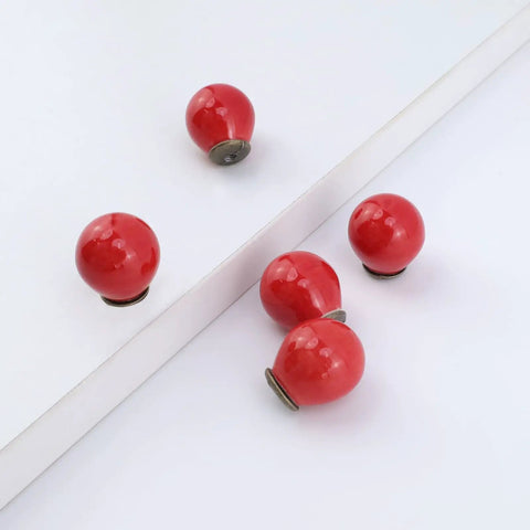 Fire Red Mini Round Cabinet Knobs And Drawer Pulls Set Of 10 With Mounting Screws Electroplated Ceramic Handles For Kitchen Cupboards, glossy red knobs on white surface.