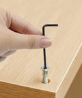 Hand using 2.5mm L Shaped Hex Key Set, 30-Piece, Black Allen Wrenches for furniture assembly on wooden board