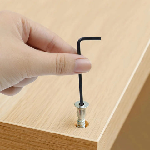 Hand using 2.5mm L Shaped Hex Key Set, 30-Piece, Black Allen Wrenches for furniture assembly on wooden board
