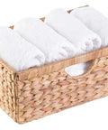 Top Notch Natural Water Hyacinth Storage Bins For Home Organization Foldable Brown Woven Baskets Set Of 3 With 6X15X10 Inch Dimensions containing rolled white towels.