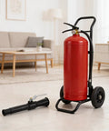 Heavy Duty Fire Extinguisher Spray Nozzle Replacement Kit For Handheld Portable Units Black Two Piece Pack beside a red fire extinguisher.
