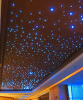 Twinkling ceiling with the Lit Starlight Headliner Kit For Cars And Home Theater, 550pcs Fiber Optic Star Lights installed in a room.