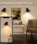 Room with Black Battery Operated Wall Sconce Set Of 2, elegant interior, dimmable lights, phone showing illumination effect.