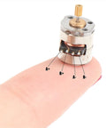 Miniature DC Stepper Motor With Gear for DIY Toys And Tiny Projects shown on a fingertip, highlighting its compact size, 4-wire connection labeled A+, A-, B+, B-.