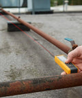 Person using 40 Meter Laser Distance Meter With One-Button Point And Click, Continuous Measurement, Area Calculator, Rugged IP54 Drop-Tested Tool