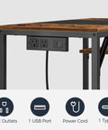 Compact Computer Desk With Built In Charging Station And USB Ports Modern Home Office Writing Desk With Two Shelves Easy Assembly Rustic Brown And Black Finish Great For Small Spaces, showing a close-up of the built-in charging hub with outlets and USB ports.