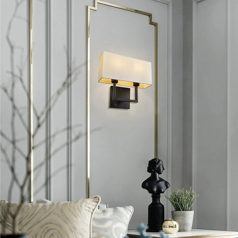 2 Light Wall Sconce With Switch installed on wall, square white fabric shade, modern transitional design for bedroom, dimmable LED compatible