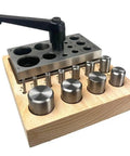 11 Piece Disc Cutter Set with Lever for Jewelry Making and Metalworking on wooden base, round punch sizes 1/8 to 1 inch.