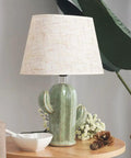 Cactus Desk Lamp With Fabric Lampshade And Sturdy Ceramic Base on a wooden table, modern bedside nightstand light for living room.