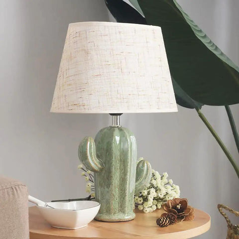Cactus Desk Lamp With Fabric Lampshade And Sturdy Ceramic Base on a wooden table, modern bedside nightstand light for living room.