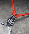 24-Inch High Leverage Compound Bolt Cutter With Stabilizer Handles cutting metal chain on concrete floor