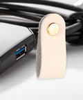 Slick Double Pack PU Leather Cord Organizer Ties For Reusable USB Charger Straps And Earphone Holders, beige leather strap close-up.