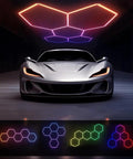 Lit RGB Hexagon Garage Light Kit With 5 Panels, 25 Pack Color Changing LED Lights, installed on garage ceiling above car.