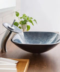 Slick Square Tempered Glass Vessel Sink For Modern Bathroom Vanity Countertops with waterfall feature on wood countertop.